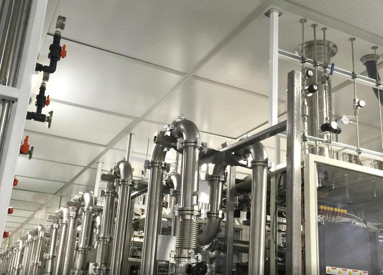 Stainless steel vacuum and bulk gas piping installed overhead in a semiconductor cleanroom