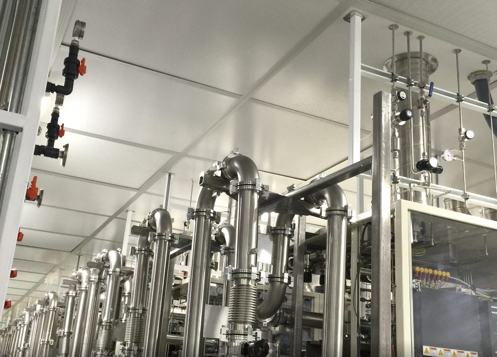 Overhead stainless vacuum and bulk gas piping installed in a semiconductor fab cleanroom