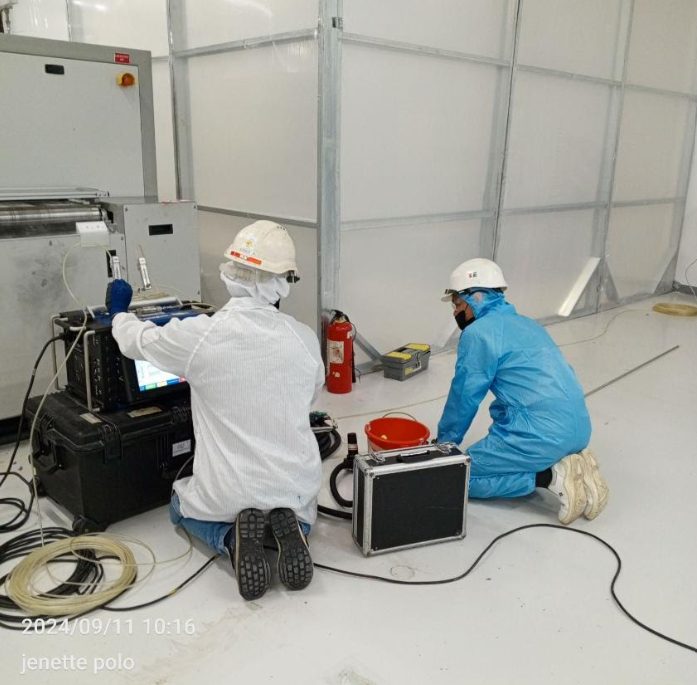 Orbital weld head clamped to stainless tool hook-up tubing inside the cleanroom