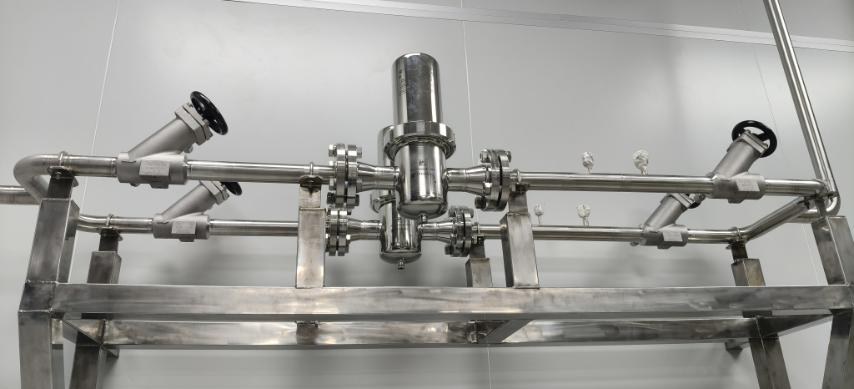 Fabricated stainless gas manifold with a filter housing and branch valves mounted on a welded frame